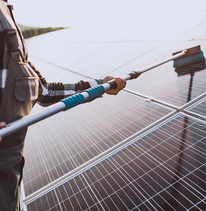 Man worker in the firld by the solar panels